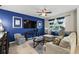 Comfortable living room with stylish blue accent wall, plush seating, and modern décor at 2920 Windmill Dr, Kissimmee, FL 34741