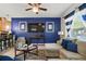 Cozy living room featuring a striking blue accent wall, plush seating and natural light at 2920 Windmill Dr, Kissimmee, FL 34741