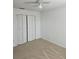 Bedroom with neutral carpet, ceiling fan, and double door closet at 2921 Puerta Del Sol Blvd, Kissimmee, FL 34744