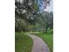 Picturesque park pathway with lush green space, mature trees, and comfortable seating at 2921 Puerta Del Sol Blvd, Kissimmee, FL 34744