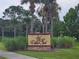 Entrance sign to Villa Sol community with palm trees and greenery at 2921 Puerta Del Sol Blvd, Kissimmee, FL 34744