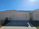 Attached garage with a paved driveway and well-maintained landscaping at 2921 Puerta Del Sol Blvd, Kissimmee, FL 34744