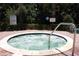 Community hot tub with seating, pool rules sign, and metal safety railing at 2921 Puerta Del Sol Blvd, Kissimmee, FL 34744