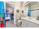 Bright bathroom with white vanity, toilet, and doorway view of the bedroom at 2958 Sunset Vista Blvd, Kissimmee, FL 34747