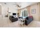 Bright living room featuring neutral tile floors, modern furnishings, and sliding doors to the pool at 2958 Sunset Vista Blvd, Kissimmee, FL 34747