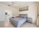 Comfortable neutral colored main bedroom featuring tile floors, bedside tables, and ensuite bath at 2958 Sunset Vista Blvd, Kissimmee, FL 34747