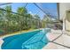 Screened-in pool with a hot tub and patio seating area at 2958 Sunset Vista Blvd, Kissimmee, FL 34747