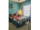 ' room with playful decor, bright colors, and a large window at 4032 Bougainvillea Pl, Kissimmee, FL 34746