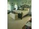 Cozy bedroom with floral bedding, comfortable furniture, and lots of decor at 4032 Bougainvillea Pl, Kissimmee, FL 34746