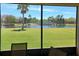 Screened view of a picturesque backyard featuring a lake with palms, and a bridge at 4032 Bougainvillea Pl, Kissimmee, FL 34746