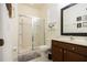 Bathroom with a glass-enclosed shower, a dark vanity, and neutral-toned walls and floors at 561 Las Fuentes Dr, Kissimmee, FL 34747