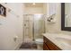 Bathroom featuring a walk-in shower with glass door and a dark wood vanity at 561 Las Fuentes Dr, Kissimmee, FL 34747