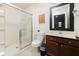 Bright bathroom featuring a tiled shower with glass doors and a dark wood vanity at 561 Las Fuentes Dr, Kissimmee, FL 34747