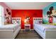 bedroom featuring cartoon themed wall decor and two beds with matching linens at 561 Las Fuentes Dr, Kissimmee, FL 34747