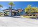 Attractive clubhouse entrance with stucco pillars and well-manicured landscaping at 561 Las Fuentes Dr, Kissimmee, FL 34747