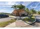 Charming two-story home with a terra cotta roof, palm trees, and convenient parking at 561 Las Fuentes Dr, Kissimmee, FL 34747