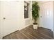 Hallway with wood floors, showing an open panel with a system unit, a plant and 2 doors at 561 Las Fuentes Dr, Kissimmee, FL 34747