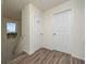 Hallway with wood floors, and two white doors, one with a window for natural light at 561 Las Fuentes Dr, Kissimmee, FL 34747