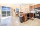 Modern kitchen with dark wood cabinets, stainless steel appliances, and a breakfast nook at 561 Las Fuentes Dr, Kissimmee, FL 34747