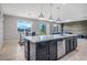 Open floor plan view of the kitchen island with stainless dishwasher, dark wood cabinets, and dining area at 624 Sardinia Circle, Davenport, FL 33837