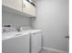 Laundry room with white appliances and cabinets for storage at 624 Sardinia Circle, Davenport, FL 33837