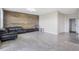 Bright living room with rustic wood accent wall, and light gray tile floors at 624 Sardinia Circle, Davenport, FL 33837