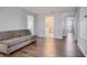 Neutral toned living room with a simple couch and wood floors at 624 Sardinia Circle, Davenport, FL 33837