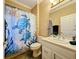 Bright bathroom features a stylish vanity and a decorative turtle shower curtain at 657 Shorehaven Dr, Poinciana, FL 34759