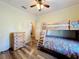 Bedroom featuring wood floors, ceiling fan, wooden bunk beds and neutral color palette at 657 Shorehaven Dr, Poinciana, FL 34759