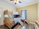 Bedroom featuring wood floors, ceiling fan, natural light and wooden bunk beds at 657 Shorehaven Dr, Poinciana, FL 34759