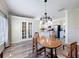 Bright dining room with modern lighting fixture and french doors at 657 Shorehaven Dr, Poinciana, FL 34759