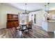 An elegant dining room with hardwood flooring, a modern chandelier and ample natural light at 657 Shorehaven Dr, Poinciana, FL 34759