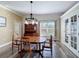 Bright dining room with hardwood floors and modern lighting fixture at 657 Shorehaven Dr, Poinciana, FL 34759