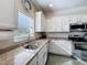 Bright kitchen features stainless steel appliances and granite countertops at 657 Shorehaven Dr, Poinciana, FL 34759