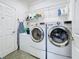 A well-organized laundry room with modern appliances, shelving, and ample space at 657 Shorehaven Dr, Poinciana, FL 34759