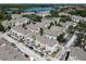 Aerial view of colorful townhomes, with a scenic lake backdrop offering serene residential community living at 6659 Times Square Ave 38-103 # Orlando, Orlando, FL 32835