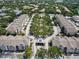 Aerial view of a community featuring colorful townhomes and a beautifully landscaped central park area at 6659 Times Square Ave 38-103 # Orlando, Orlando, FL 32835