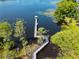 Beautiful aerial view of a lake with a long dock and gazebo, surrounded by lush vegetation and condos at 6659 Times Square Ave 38-103 # Orlando, Orlando, FL 32835