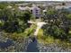 Picturesque aerial view of the condos, lush greenery, and a serene lake with lily pads at 6659 Times Square Ave 38-103 # Orlando, Orlando, FL 32835