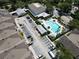 An aerial view showcasing a community pool and clubhouse amidst well-maintained landscaping and ample parking at 6659 Times Square Ave 38-103 # Orlando, Orlando, FL 32835