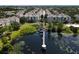 Stunning aerial view of a lake with a dock and gazebo in a condominium community surrounded by lush greenery at 6659 Times Square Ave 38-103 # Orlando, Orlando, FL 32835