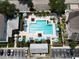 Aerial shot of pool area featuring lounge chairs, umbrellas, landscaping and a cabana-style structure at 6659 Times Square Ave 38-103 # Orlando, Orlando, FL 32835