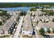 Aerial view of well-maintained townhomes and a scenic lake in the background, creating a peaceful neighborhood setting at 6659 Times Square Ave 38-103 # Orlando, Orlando, FL 32835