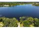 Expansive aerial view of a community lake with lush greenery and condo buildings in the background at 6659 Times Square Ave 38-103 # Orlando, Orlando, FL 32835