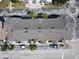 Aerial view showing rooftops and palm trees, plus parked cars and garages of townhome buildings at 6659 Times Square Ave 38-103 # Orlando, Orlando, FL 32835