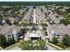 Aerial perspective highlights the grand entrance to a community with lush landscaping and colorful townhomes at 6659 Times Square Ave 38-103 # Orlando, Orlando, FL 32835