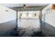 Spacious garage with dark epoxy floors and an open view to the neighborhood streetscape at 6659 Times Square Ave 38-103 # Orlando, Orlando, FL 32835