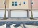 A close-up view showing the garage of the building, with palm trees flanking the entrance and a clear address marker at 6659 Times Square Ave 38-103 # Orlando, Orlando, FL 32835