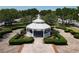 An eye-level view shows the gazebo surrounded by manicured hedges and lush landscaping at 6659 Times Square Ave 38-103 # Orlando, Orlando, FL 32835