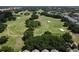 Aerial view shows the meticulously manicured greens of a picturesque golf course within a community at 6659 Times Square Ave 38-103 # Orlando, Orlando, FL 32835